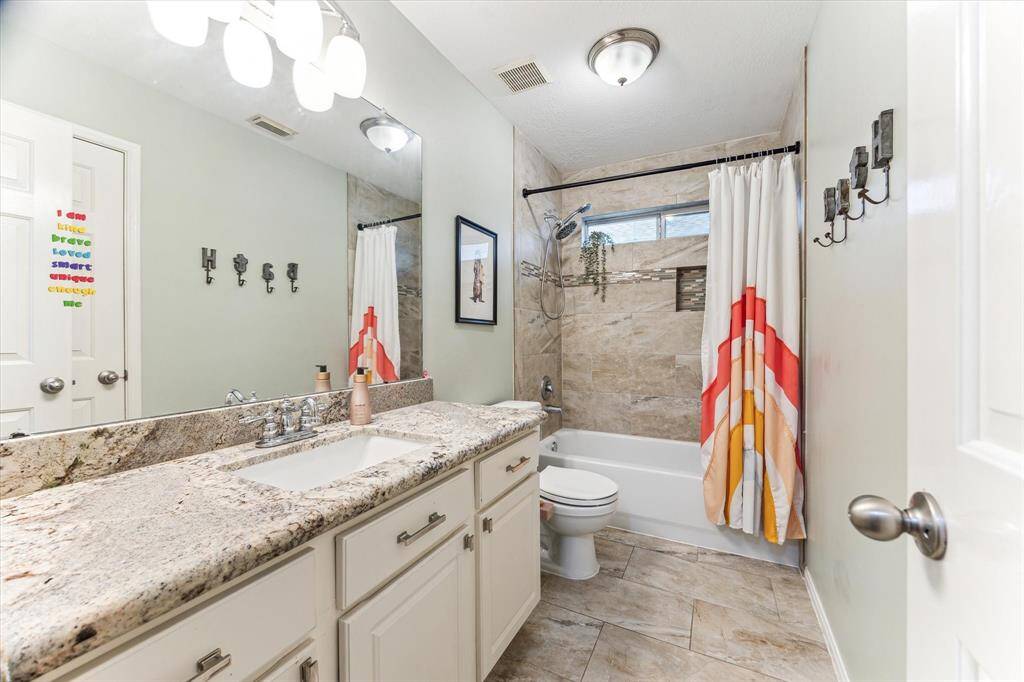 This 1st floor bath/shower combo with updates is shared by the secondary bedrooms.