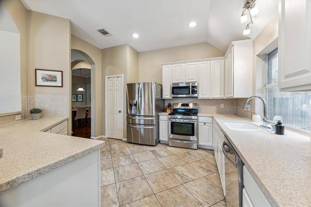 Another view of this large kitchen with stainless appliances and plenty of counterspace for the gourmet chef.  Large window is located about the sink.
