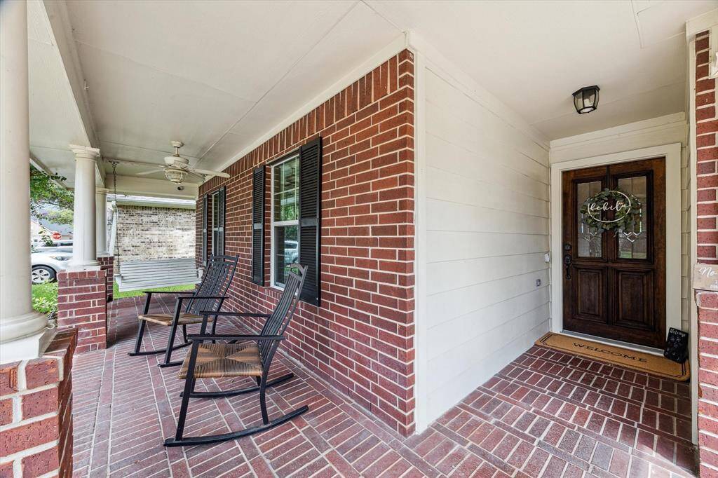 Welcoming covered front porch with a swing, a ceiling fan and room for your favorite rocking chairs in the sought after community of Stonebridge at SilverLake.  Nicely covered front porch leads into a spectacular home.