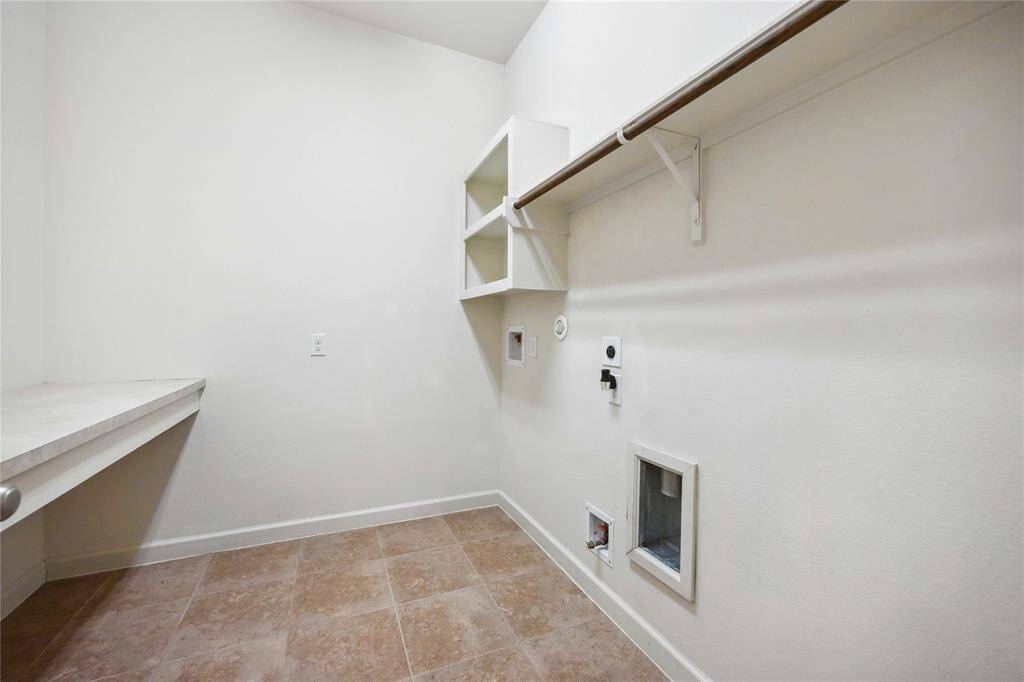 Laundry room with a built-in countertop.