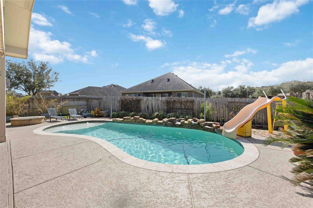 Walk around the pool with ease on the cool deck and enjoy the rock waterfall and slide.