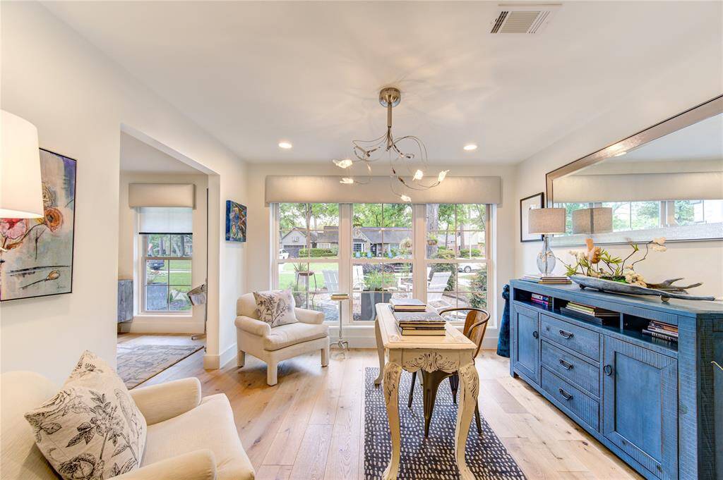 This light filled room off the dining room overlooks the front yard from large double pane picture windows and is versatile for another sitting room, playroom, or a home office.