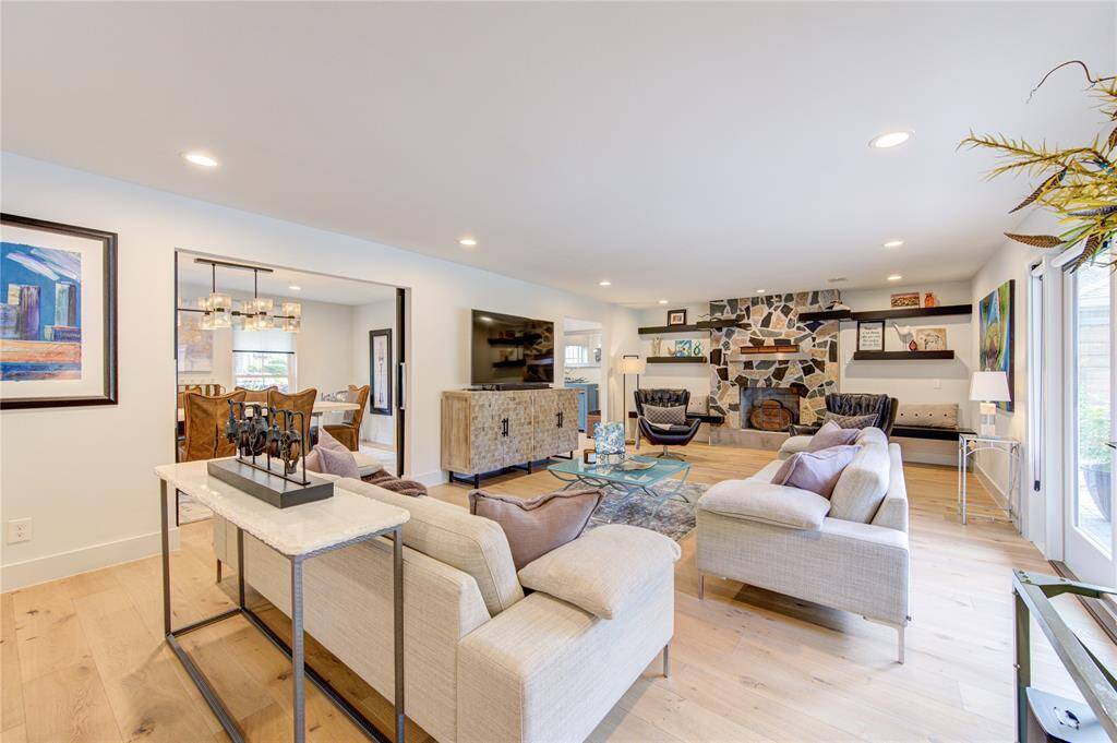 Every detail of this home was well thought out and planned with custom details, including this gas log fireplace that was created from Granite remnants during the house remodel. The built-in seating on each side of the fireplace offers additional seating when entertaining, or a great spot to read a book next to a warm fire in the winter.