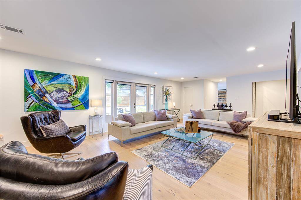 The expansive living room is full of natural light with amazing views of the private backyard. The gorgeous French oak floors add warmth and style to the clean lines of this home.