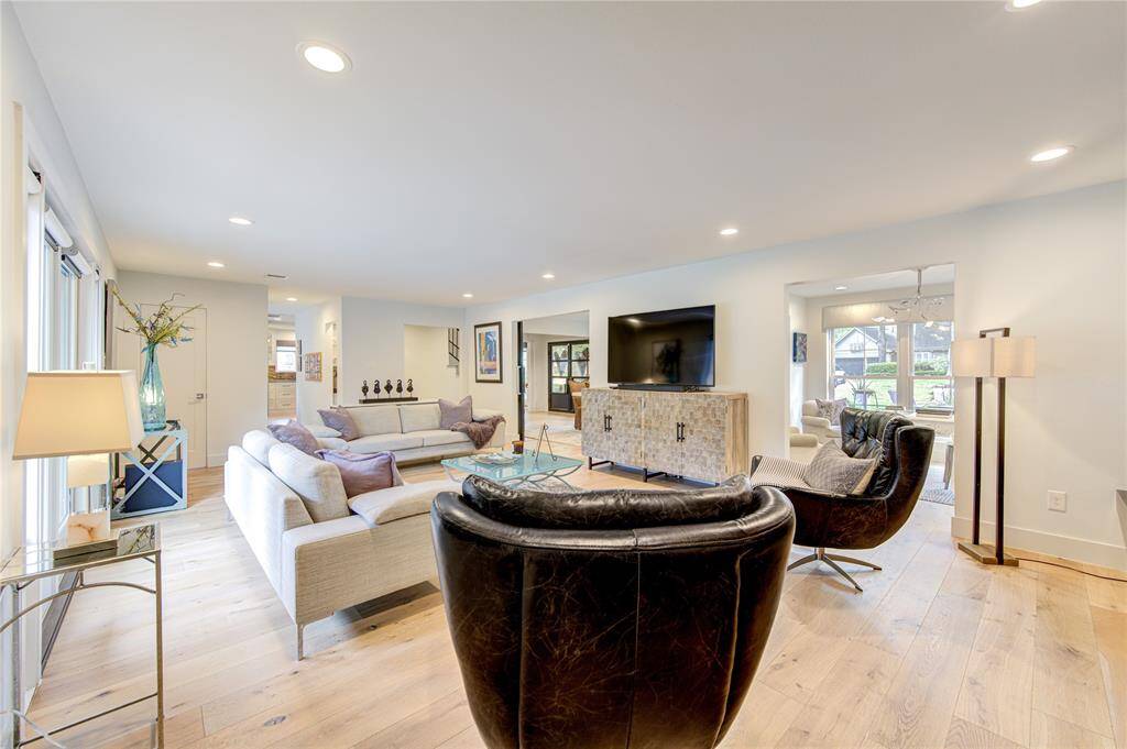 Although modernized, the French Oak floors and white walls are timeless to blend with any decor. The removal of the baseboards creates clean lines throughout with LED lighting.