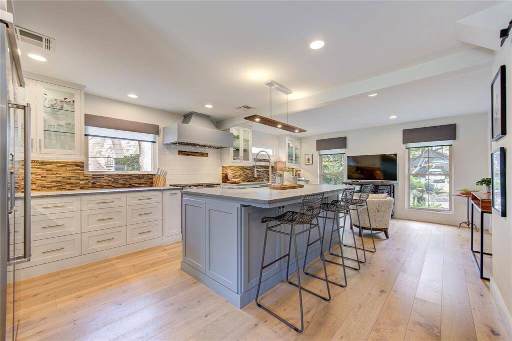 The island kitchen reflects the style and comfort of new construction with tons of cabinet and counter space as well as an extra sitting area overlooking the front of the home.
