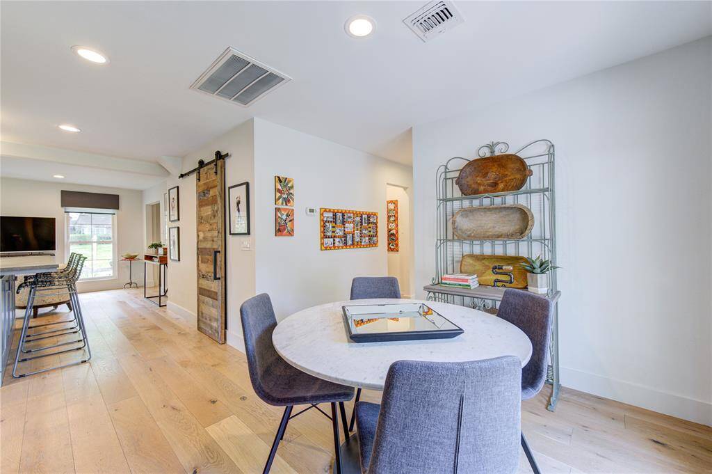 The Sunny Breakfast Room boasts views of the private backyard and pool through a double pane French Door. Every room downstairs offers access to the backyard and the abundance of windows fills this home with natural light.