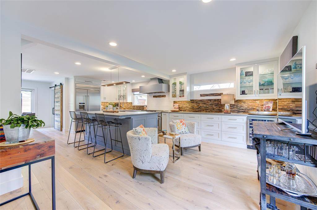 The Kitchen was expanded into the former dining room after the downstairs remodel so in addition to an abundance of cabinets, there is an extra sitting area that offers a gathering spot for the family or guests to hang out in the kitchen.