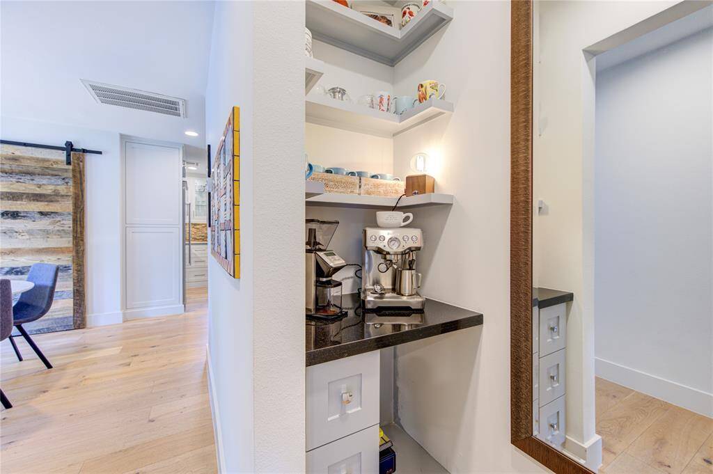 This space that was formerly a wet bar has now been converted into a modern coffee bar or wine storage. The Seller really has made use of every space in this home.