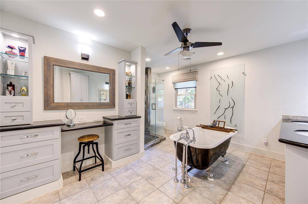 The ensuite primary bath offers a spa like retreat complete with a Double sink vanity, a makeup vanity, and freestanding tub.
