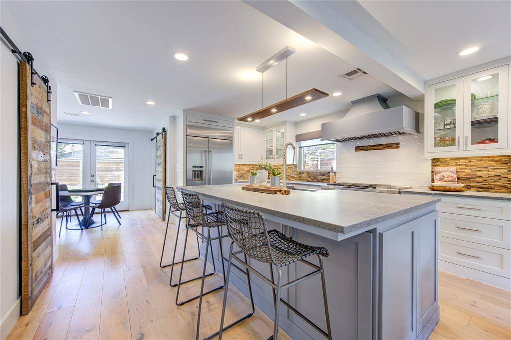 The walls have been opened to expand the kitchen into this Culinary Delight where a huge center island will invite family and friends to gather. The Luxurious French Oak Floors flow throughout the first floor and are the hottest floors in high end homes today.
