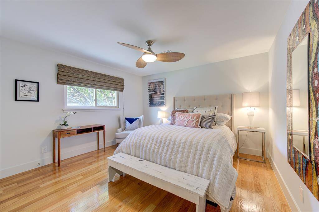 All the crown molding was removed upstairs with modern baseboards added to match the modern look of the downstairs. This spacious bedroom easily accommodates a queen bed with lots of extra space.