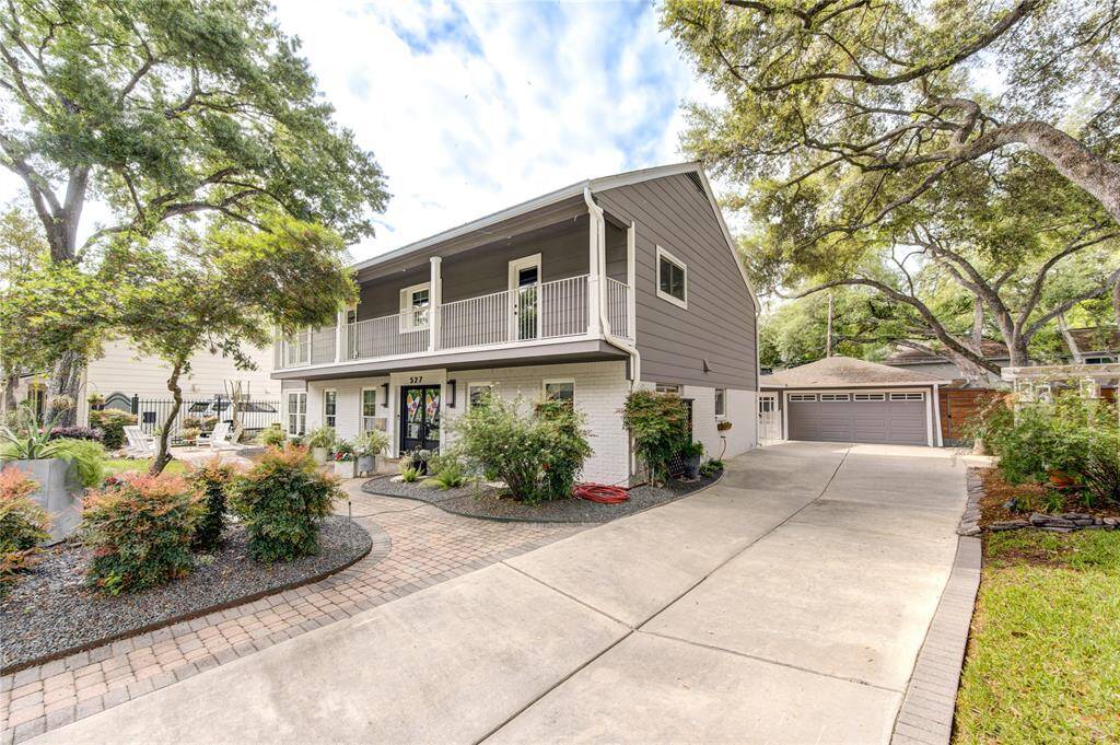 A double wide driveway offers plenty of extra parking, and even the side yard has been beautifully landscaped with a Pergola and swing for enjoying the outdoors.