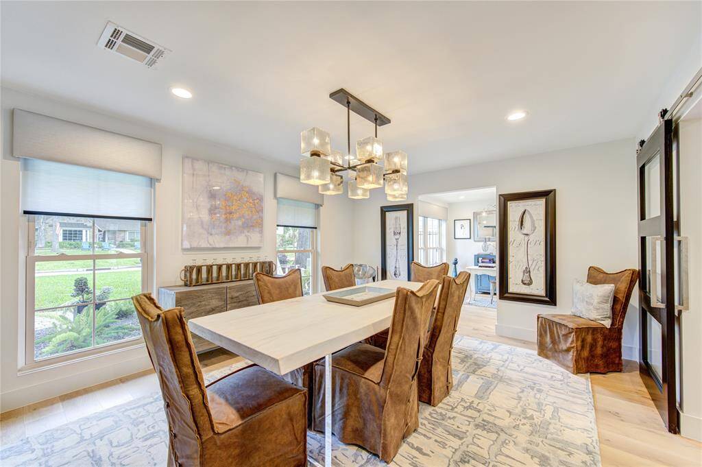 The original floorplan has been modernized with wider openings, including a wall from the dining room to the living room. The glass barn doors offer the versatility of closing the space. LED recessed lights throughout keep the interiors light and bright even when the sun sets.