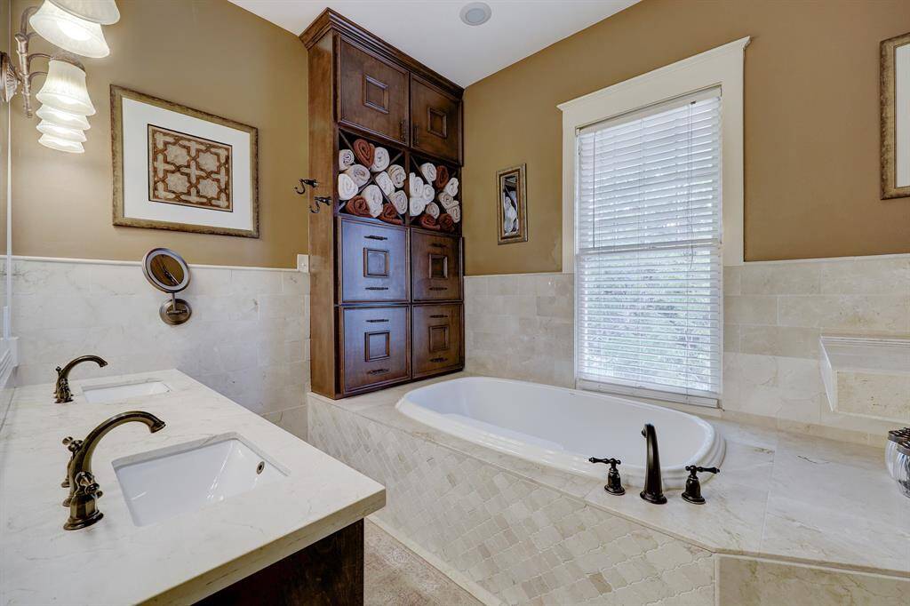 Enjoy the Double Vanity in primary bathroom with shower and soaking tub