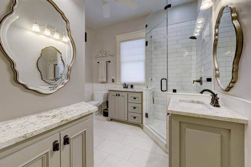 Secondary bath upstairs with two separate vanity areas. Crema Marfil Marble throughout
