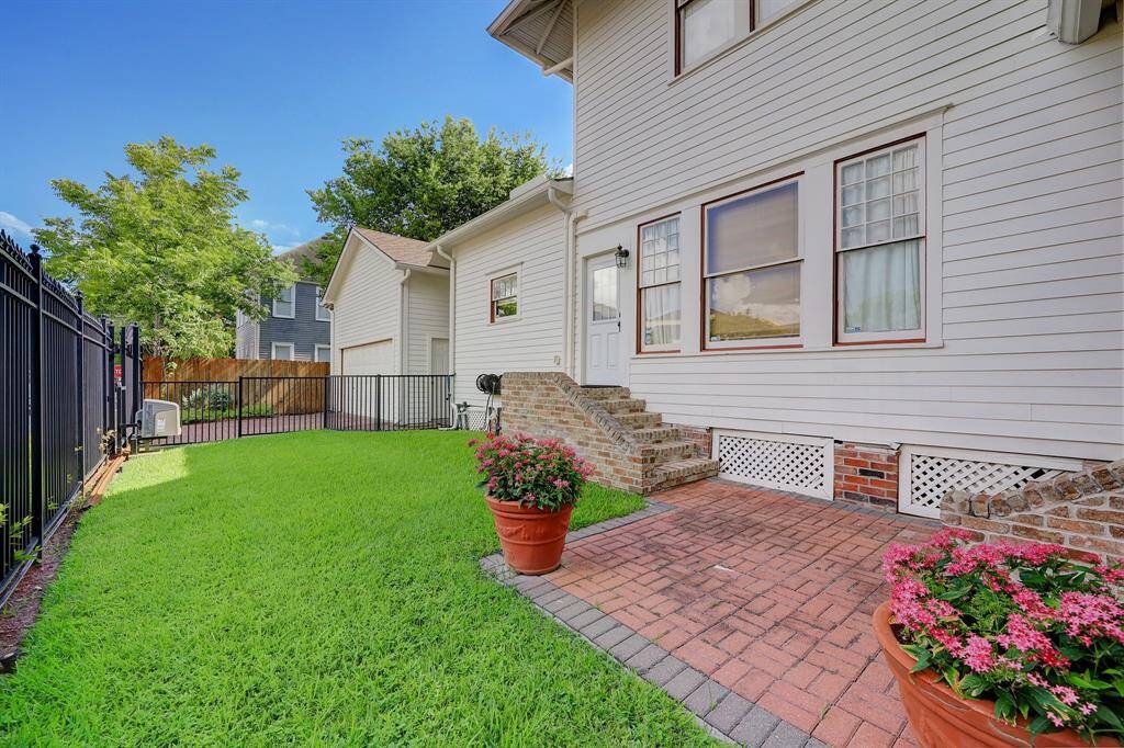 Side yard with plenty of green space.