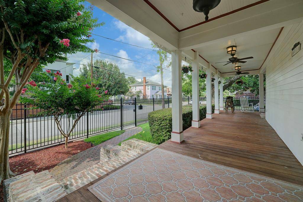 A view of the large porch and yard from your front door.