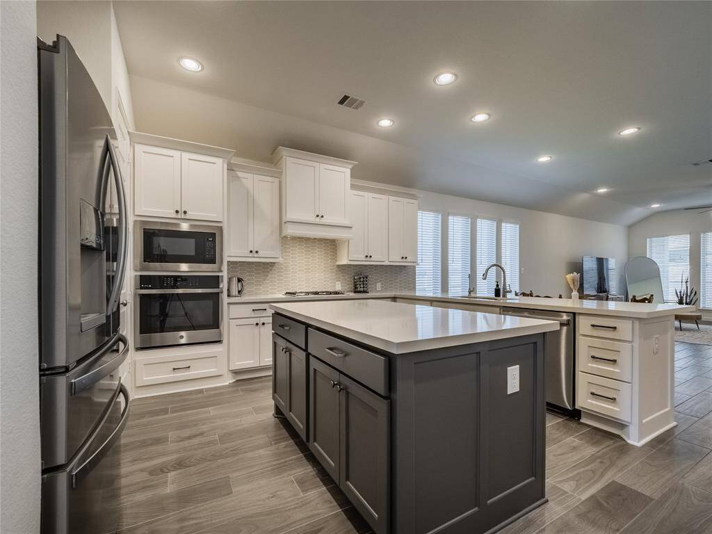 as you continue down the entrance hall next is the kitchen, this is an open floor plan very spacious