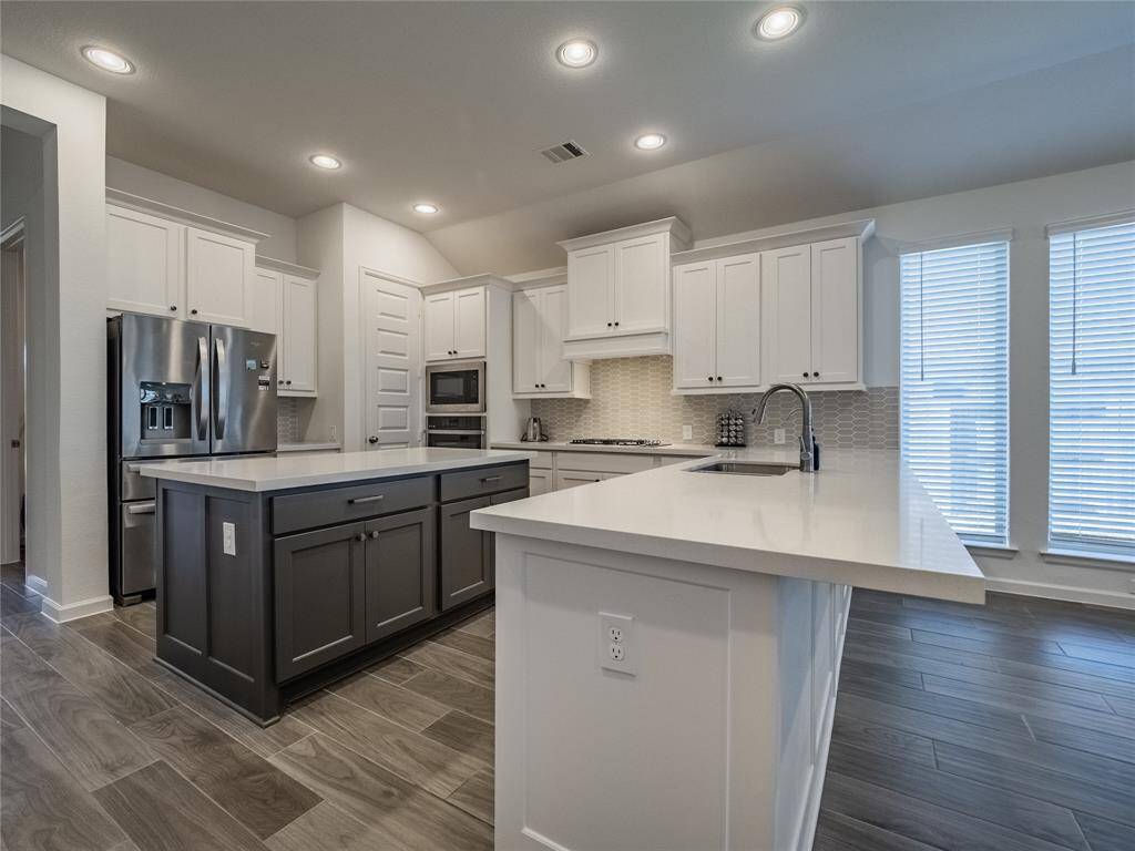 your kitchen has an oversized counter top great for bar stools, island with granite counter top gives the cook plenty of room to prepare the meals and lots of storage and electricty