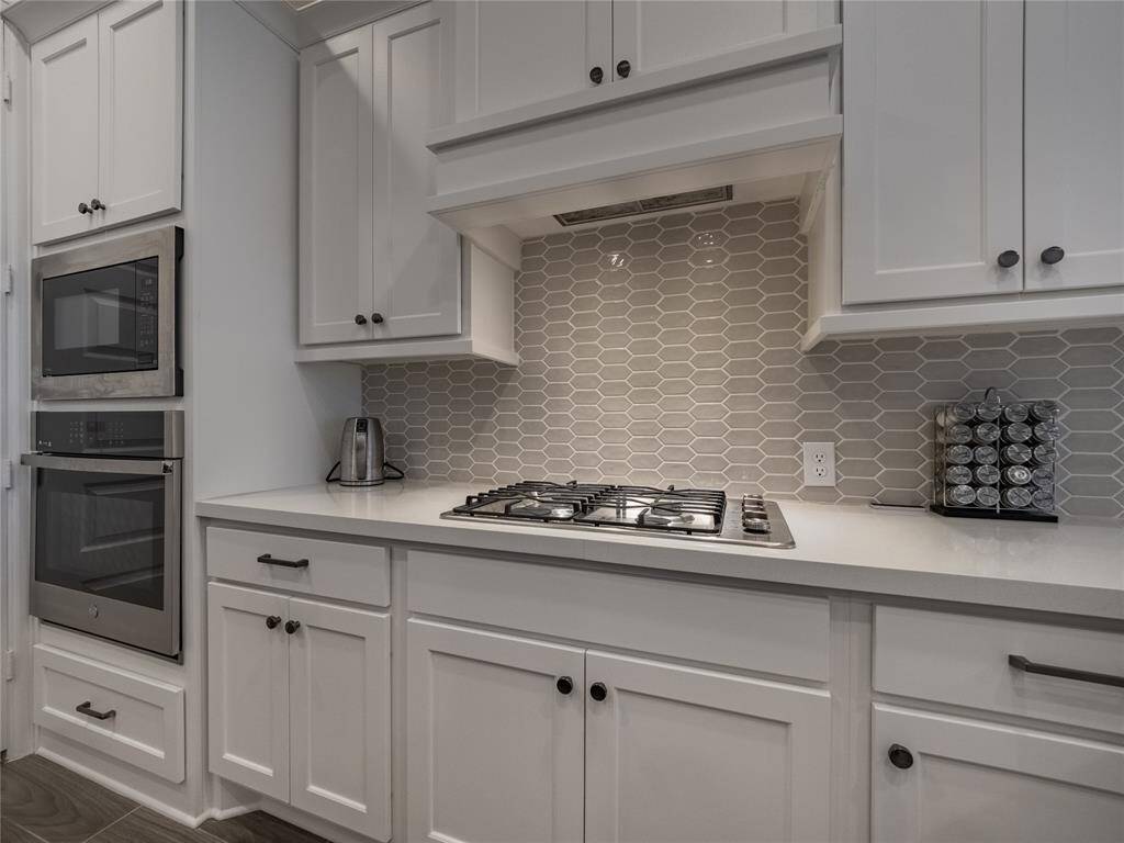 you have the beautiful white cabinets with the outstanding backsplash gas range top lots of cabinet space