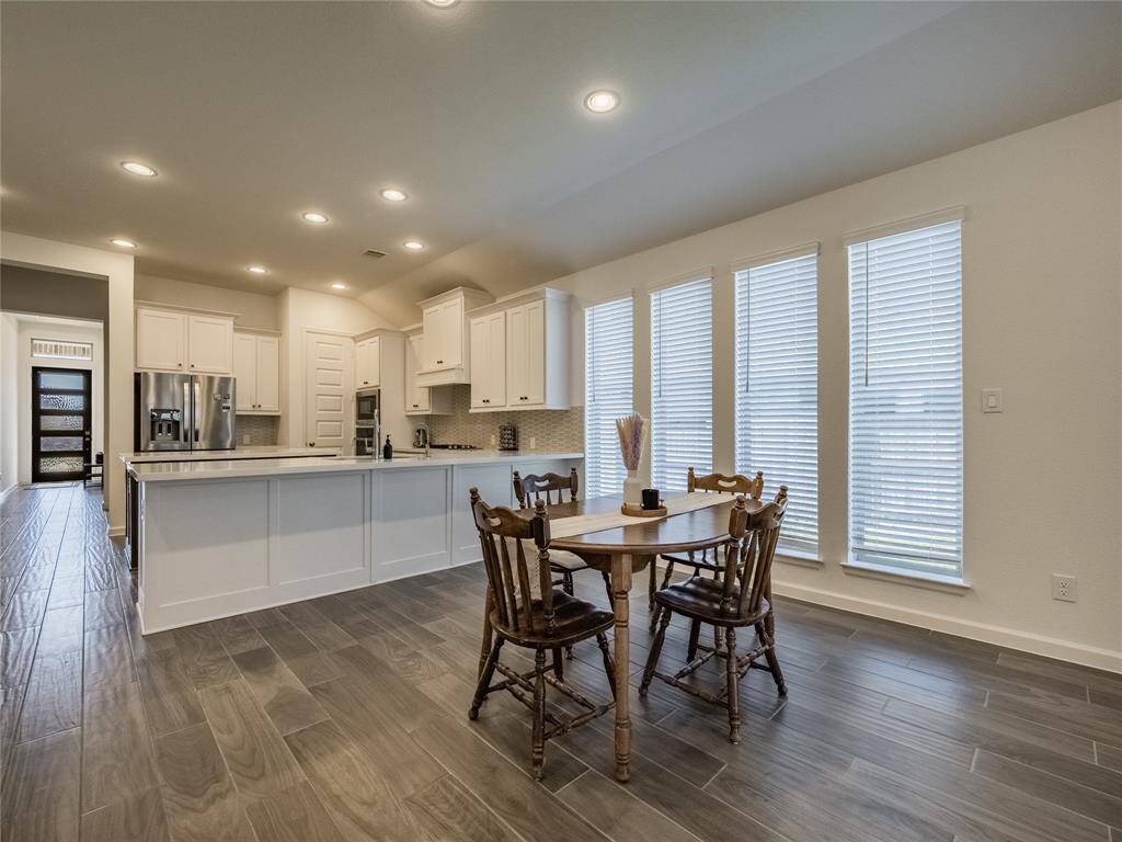 with this open floor plan you have your dining area and these beautiful tile floors flow through the main living area carpet in bedrooms only, have the extra long windows that give a lot of natural light , recessed lighting