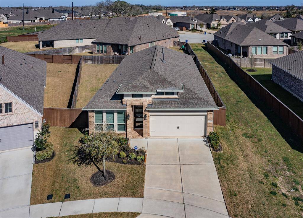 from this aerial view you can see the side yard the double driveway plus double garage with poxy flooring