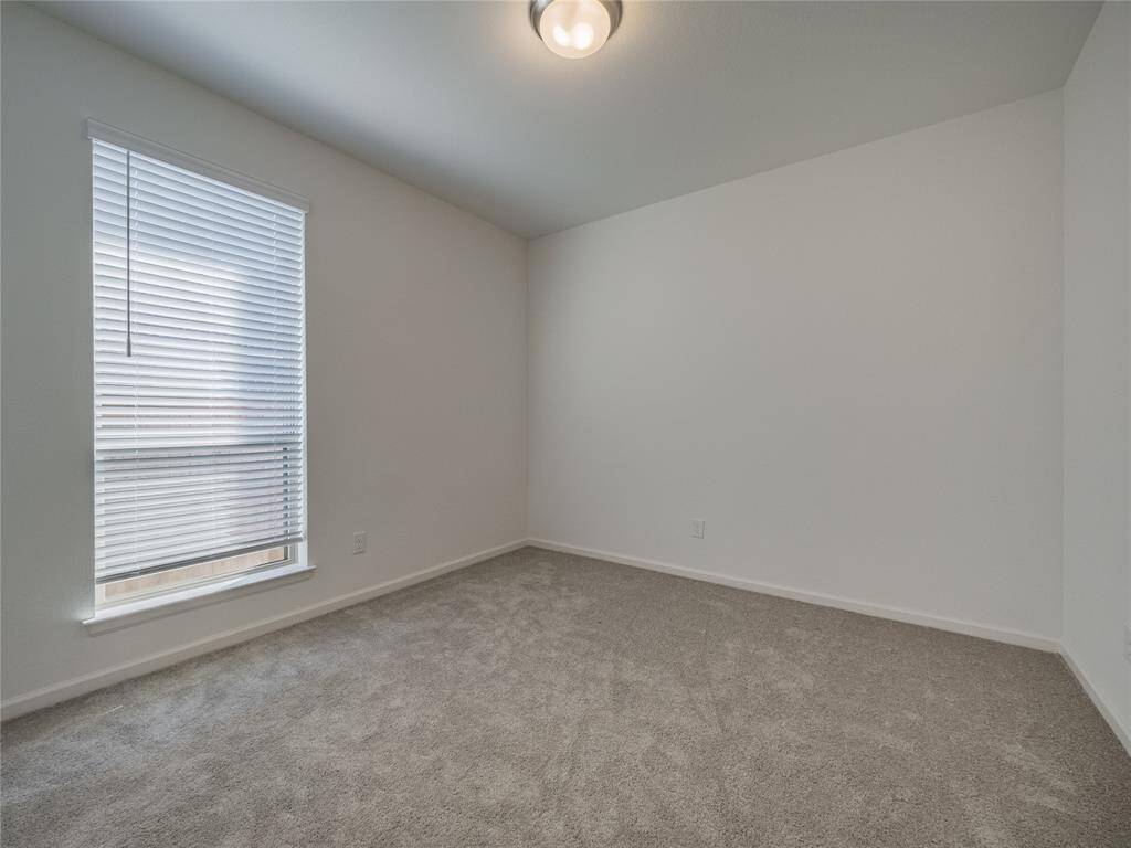 right past the mudd area is bedroom 3 hardly used carpet like new oversized window