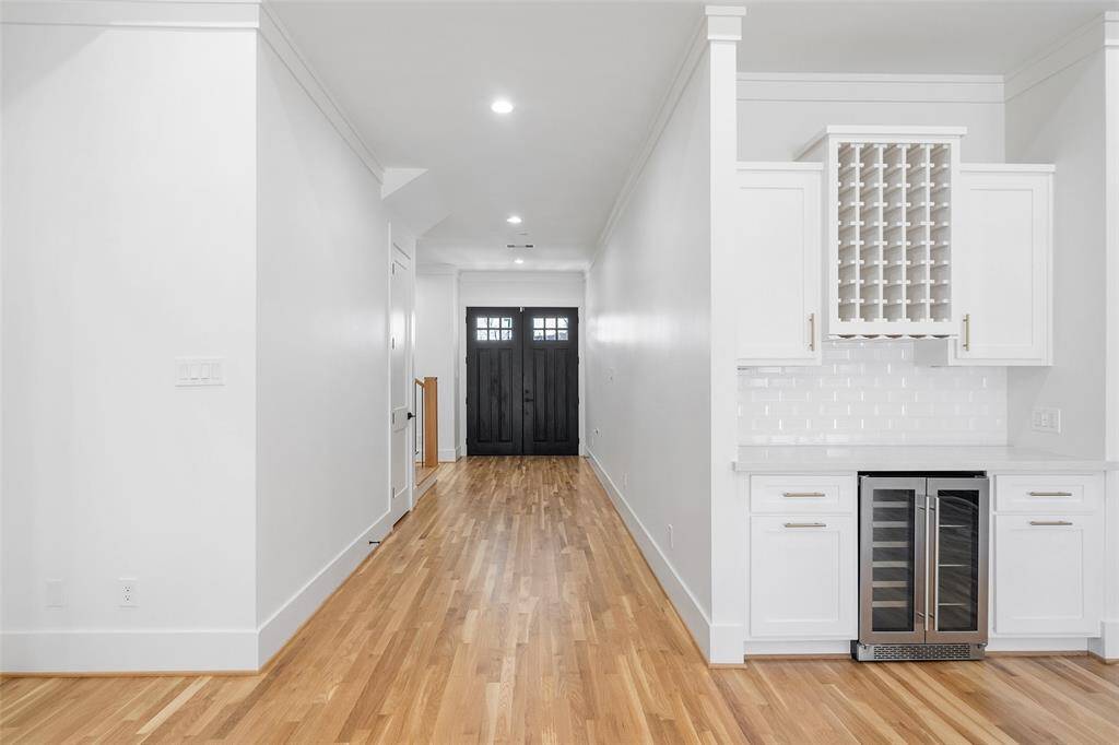 Built-n wine bar and hallway leading to the private office and staircase.