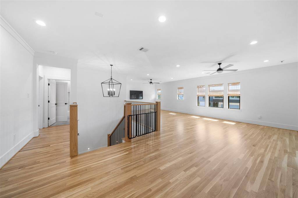 Upstairs landing and game room. Notice the gorgeous refinished white oak wood floors throughout the entire home!