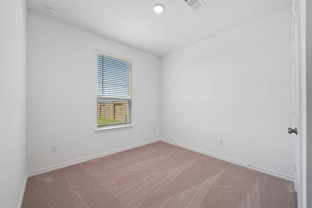 downstairs secondary bedroom with adjacent full bath