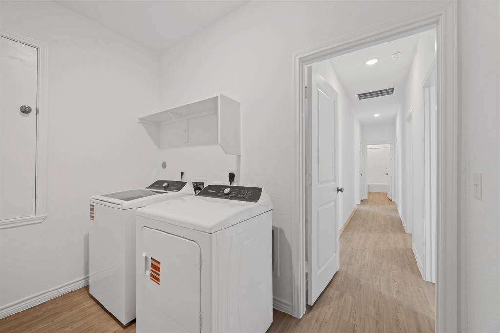 oversized laundry room with move in ready whirlpool washer and dryer