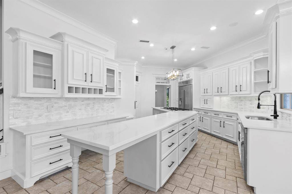 An abundance of custom cabinets and Quartz countertops, offering plenty of storage space!