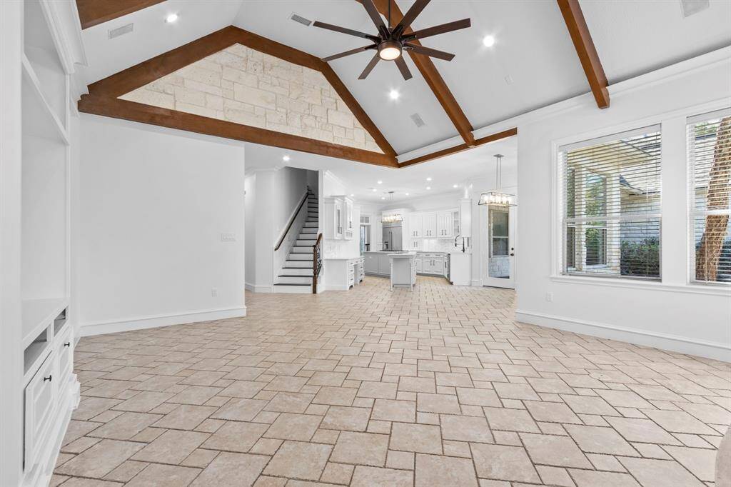 The open concept floor plan effortlessly transitions into the kitchen, creating a harmonious and spacious layout.
