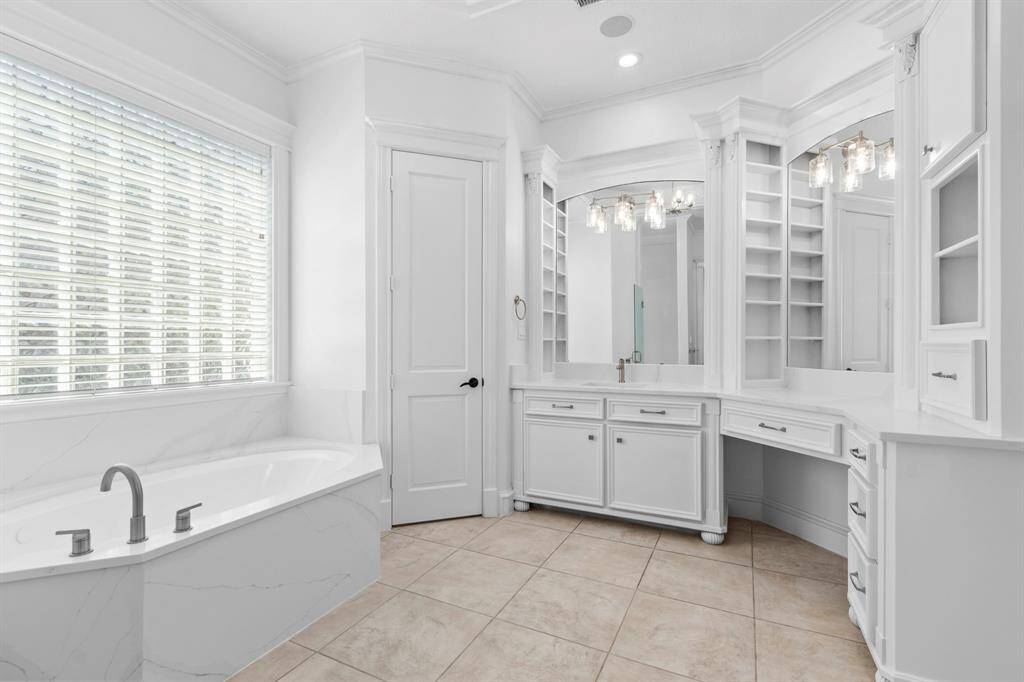 Luxurious primary bathroom featuring a Quartz - surrounded jetted tub for ultimate relaxation time.