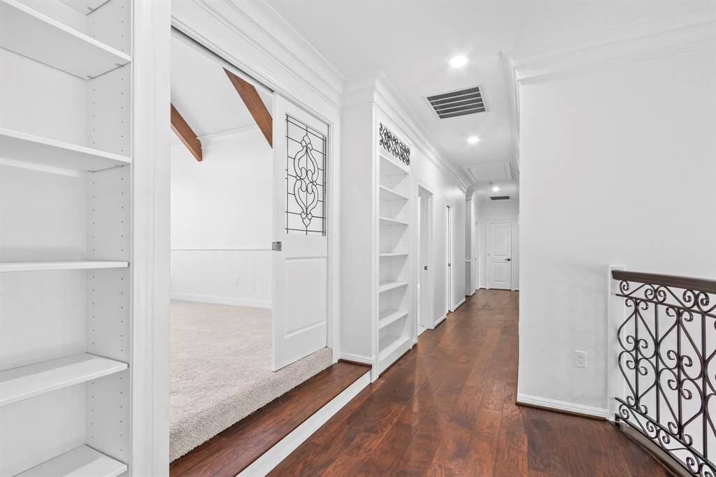 The game room features stunning pocket doors with elegant leaded glass accents, ideal for shutting out any noise from children playing games.