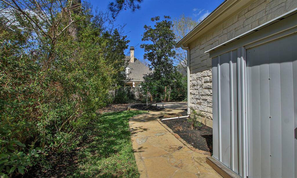 The side of the house features a shed that will remain with the property.