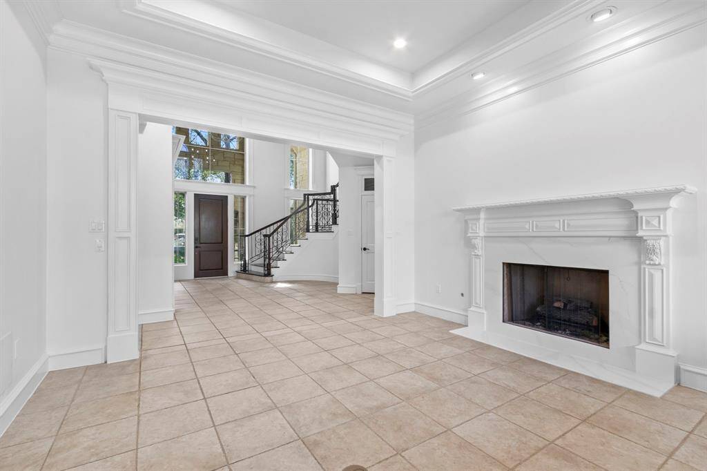 Elegant formal living room featuring cove lighting in the ceiling and exquisite millwork.