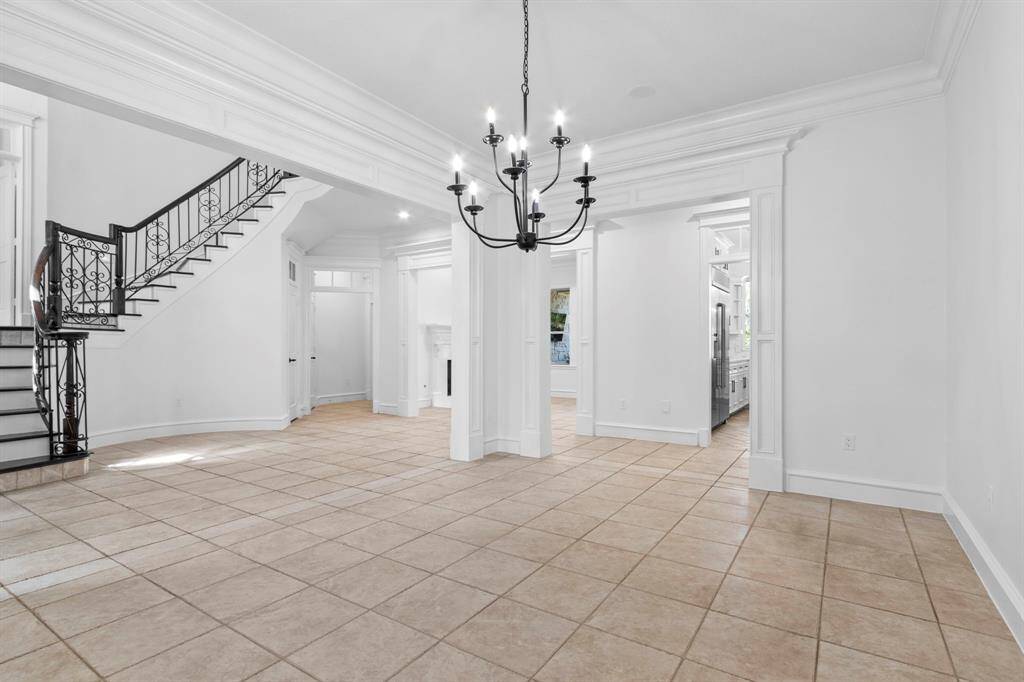 Elegant formal dining room featuring a new light fixture and custom-paneled detailing.
