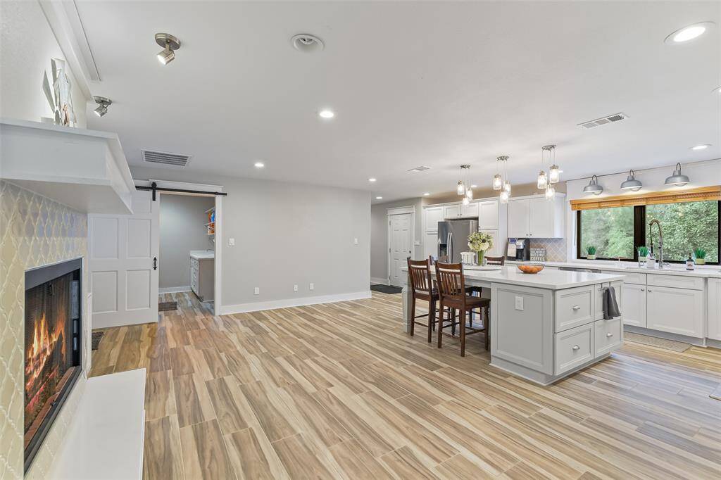 Elegant quartz countertops enhance the kitchen, laundry, bathrooms, and fireplace hearth.