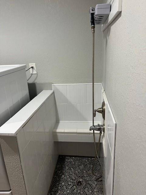 Elegant and convenient pet shower stall in laundry room.