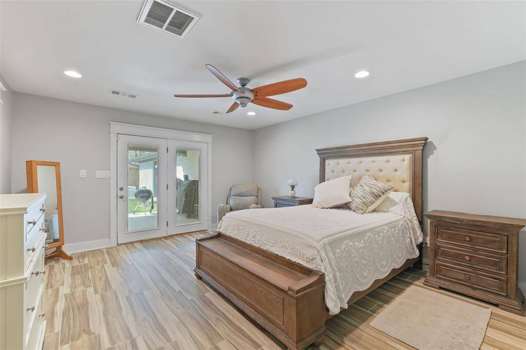 Serene primary bedroom featuring recessed lighting, a ceiling fan, and French doors leading to the patio.