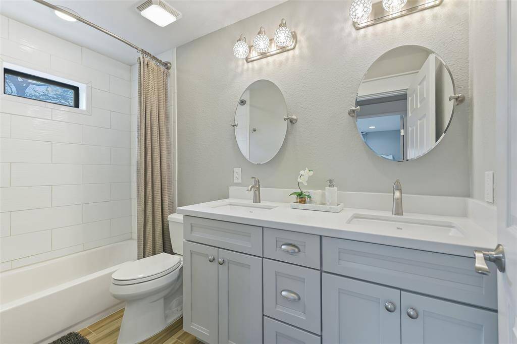 Secondary full bathroom with double sink and stunning modern finishes.