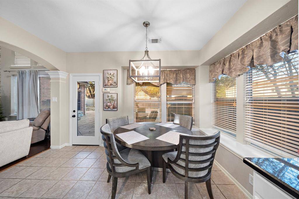 This charming breakfast room offers easy access to the outdoor patio and serves as a central gathering spot that bridges the kitchen and living spaces. Its open layout and proximity to the kitchen make it ideal for everyday meals or entertaining guests.
