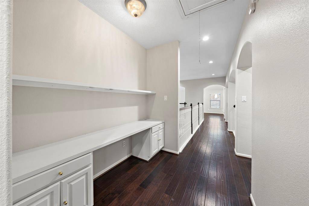This built-in desk area along the upstairs hallway provides a practical and private space for working or studying. Custom cabinetry adds storage convenience.
