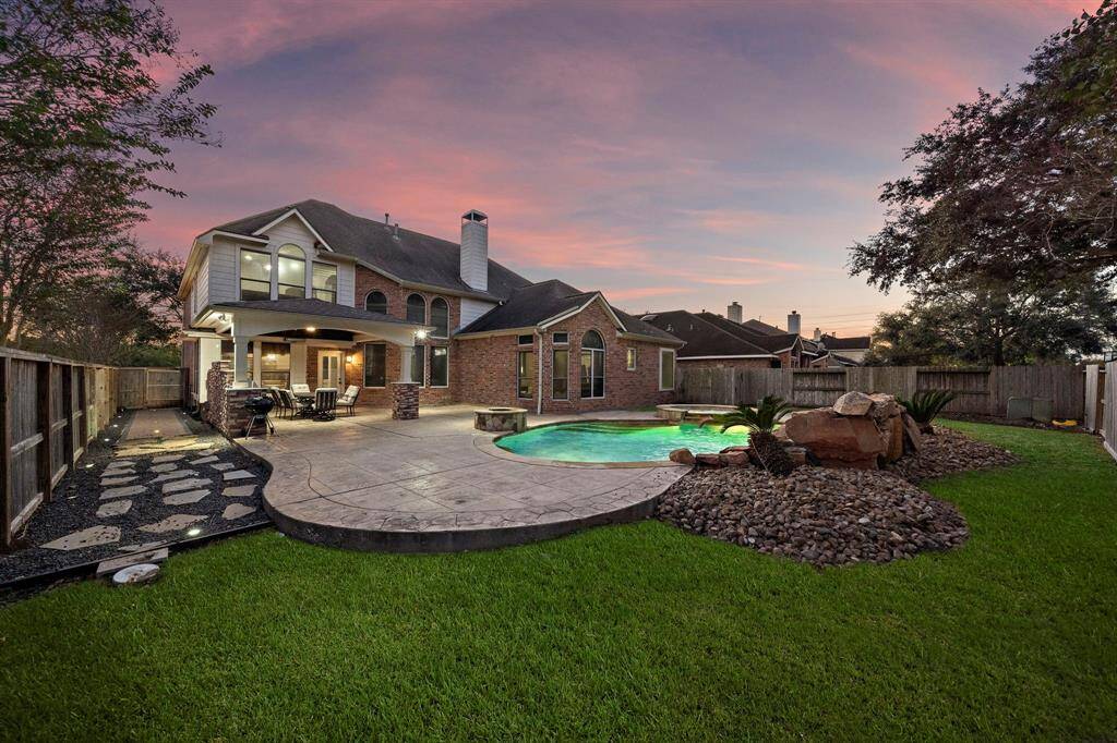 The expansive pool deck offers ample space for lounging, dining, or simply soaking in the peaceful ambiance of your private backyard sanctuary.