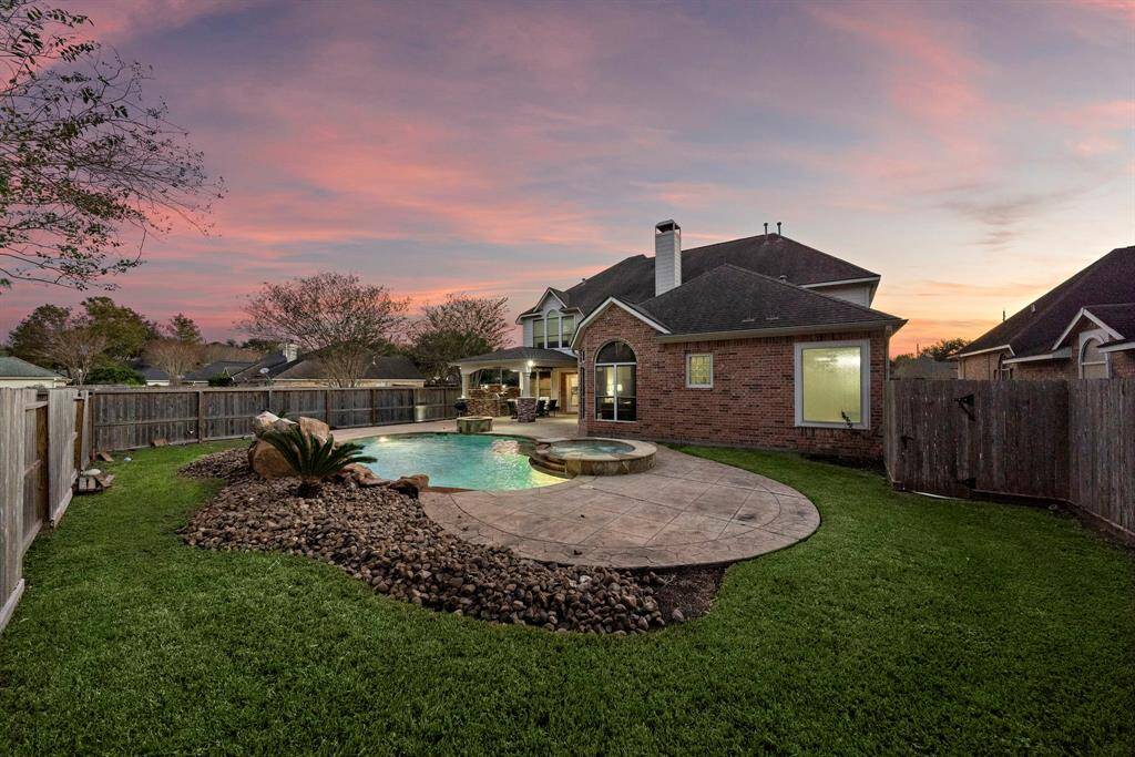 Thoughtfully designed landscaping includes soft lighting that highlights the beauty of the yard and adds charm to evening gatherings.