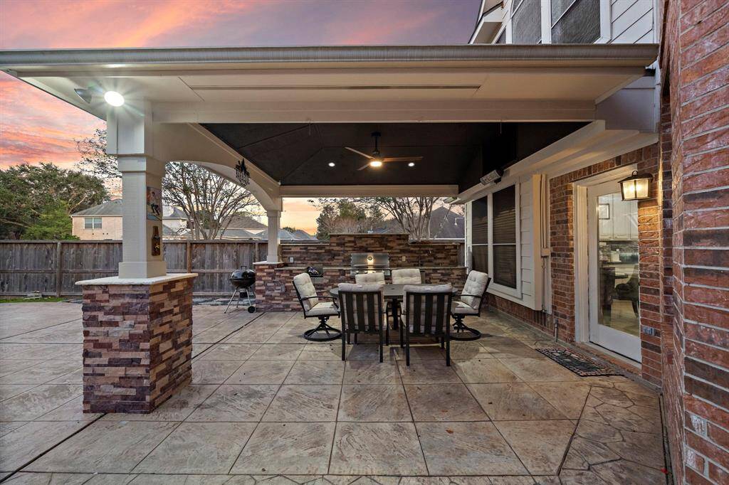 Host unforgettable gatherings with a built-in outdoor kitchen and grilling area, all under the comfort of a spacious covered patio.