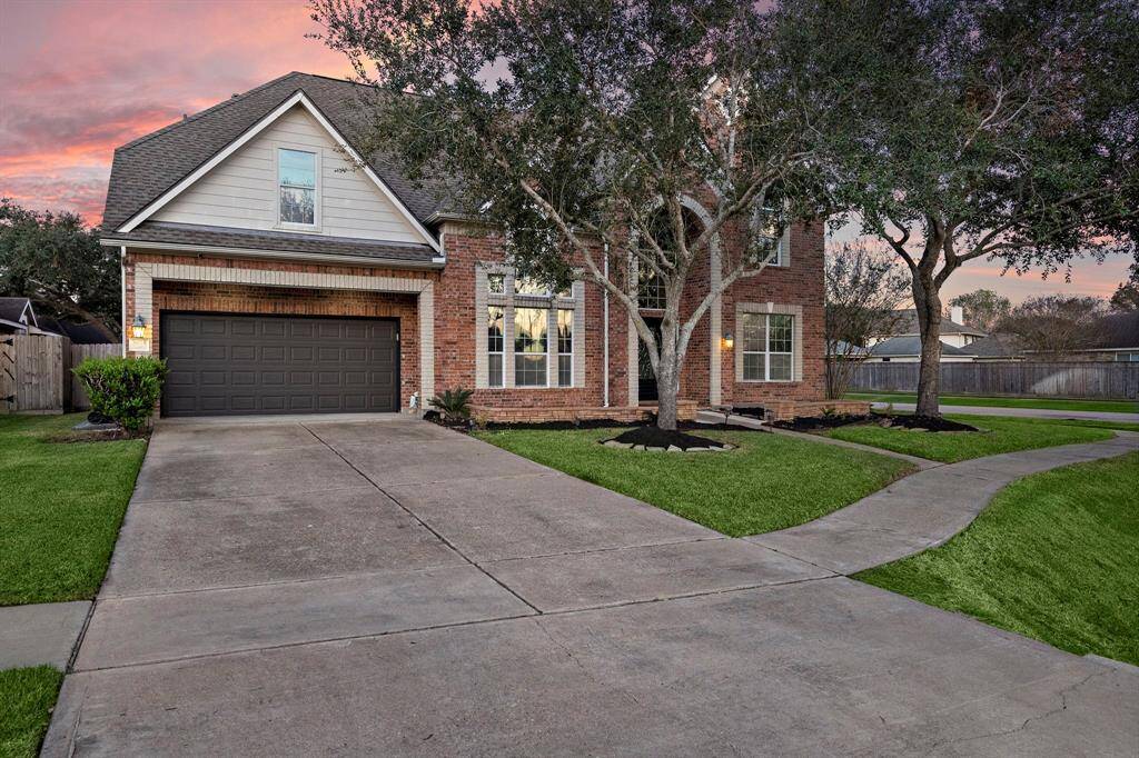 The home's timeless design is complemented by well-maintained landscaping and a corner lot location, offering both privacy and style.