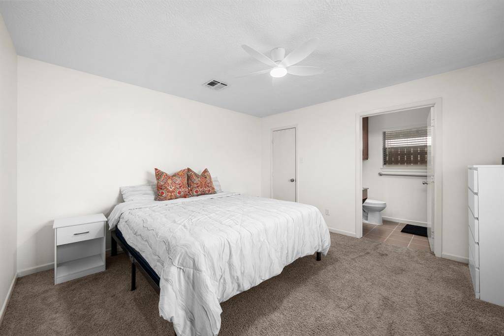 Private primary bedroom off the living room on the left hand side.